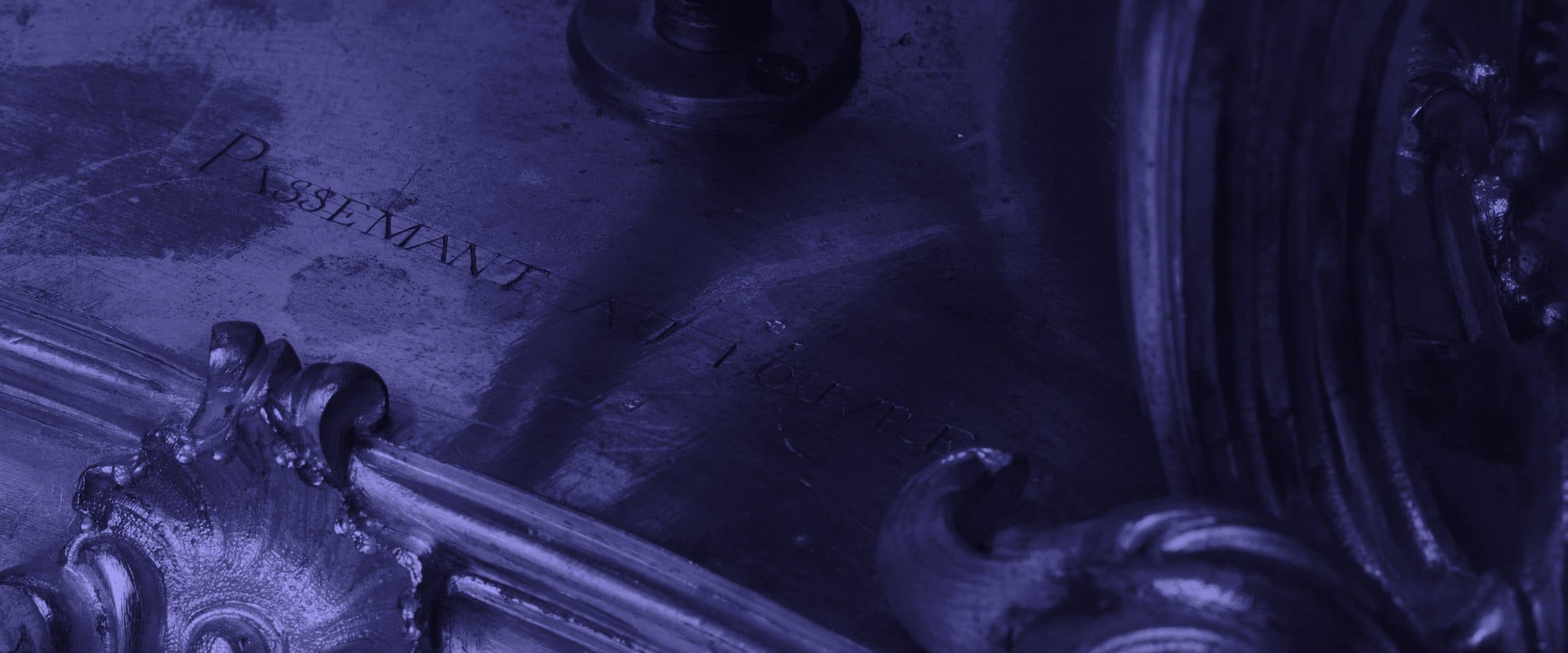 Close detail of an eighteenth-century gilt bronze microscope stand engraved with its maker’s name.